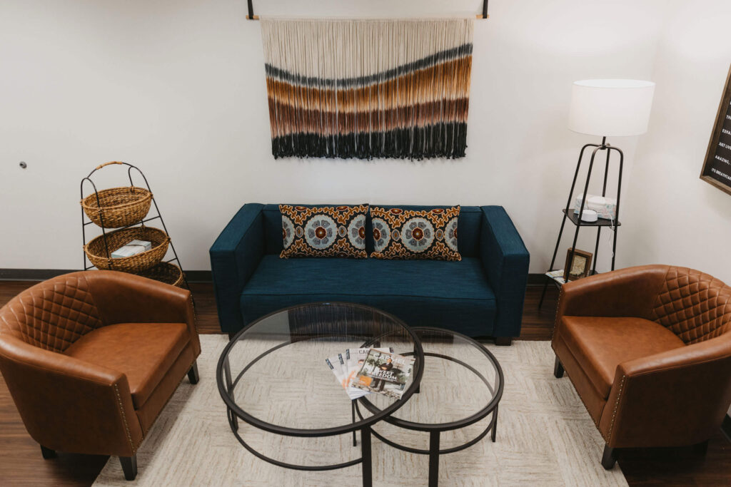 Two chairs and a sofa arranged for conversation in the Beyond the Sun clinic