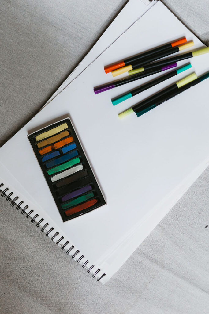 A sketchbook spread with chalk pastels and dual-tip brush pens